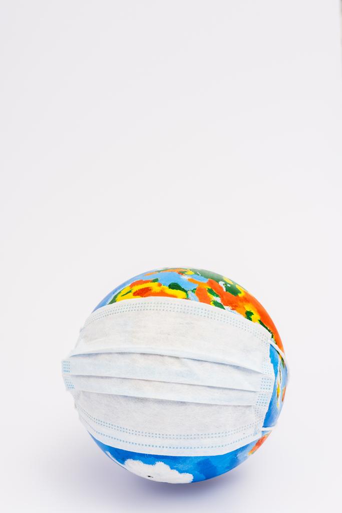 globe in protective medical mask on white with copy space - Photo, Image