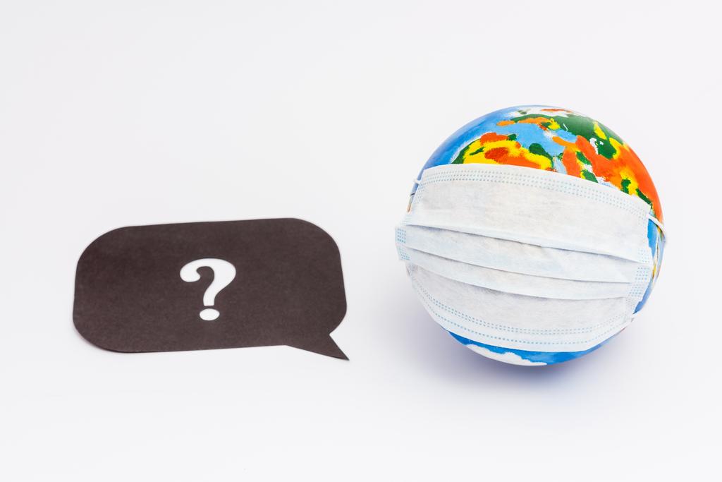 globe in medical mask near speech bubble with question mark on white  - Photo, Image