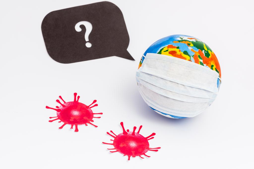 глобус в медицинской маске рядом с пузырём речи с вопросительным знаком и нарисованным вирусом на белом
  - Фото, изображение