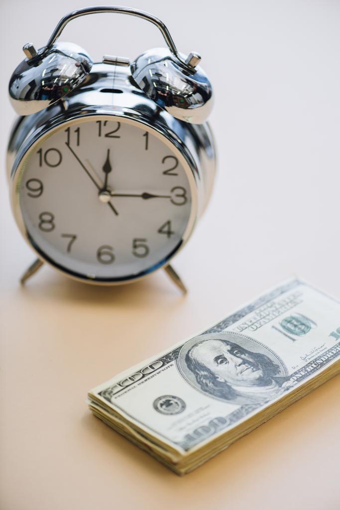 Dollar banknotes and alarm clock on white background - Photo, Image