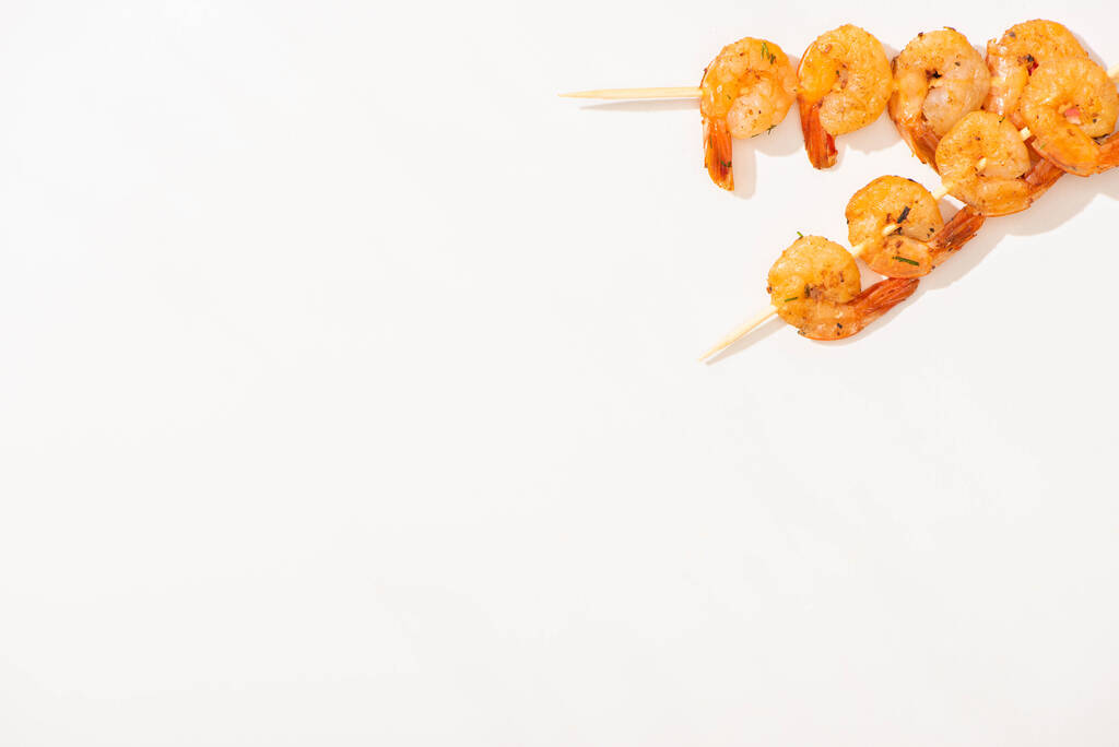 top view of delicious fried prawns on skewers on white background - Photo, Image