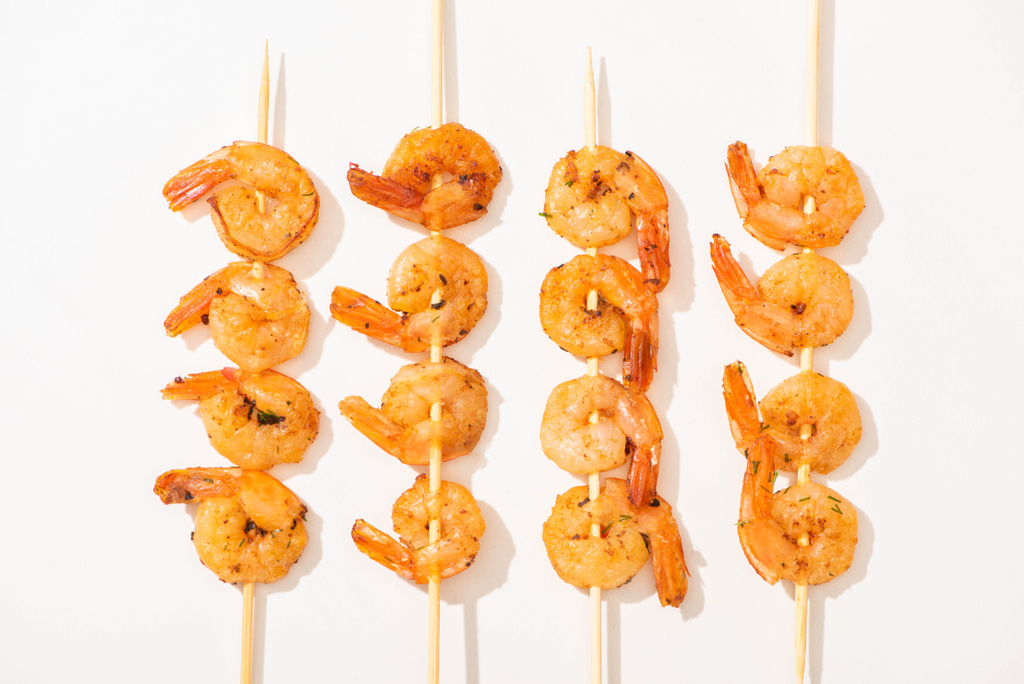 top view of delicious fried prawns on skewers on white background - Photo, Image
