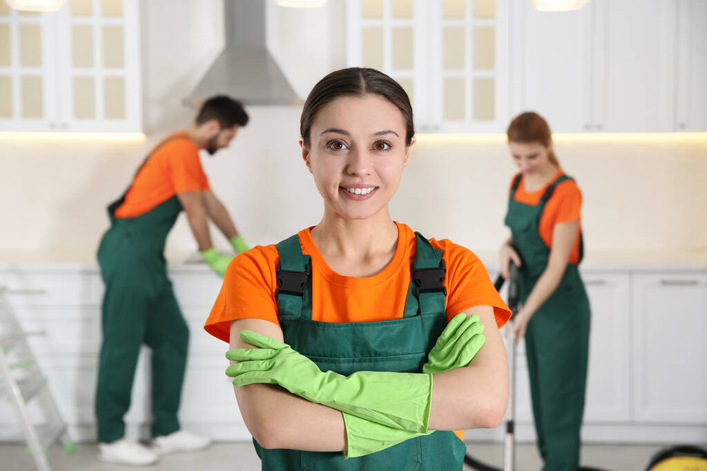 Professional janitor in uniform indoors. Cleaning service - Photo, Image