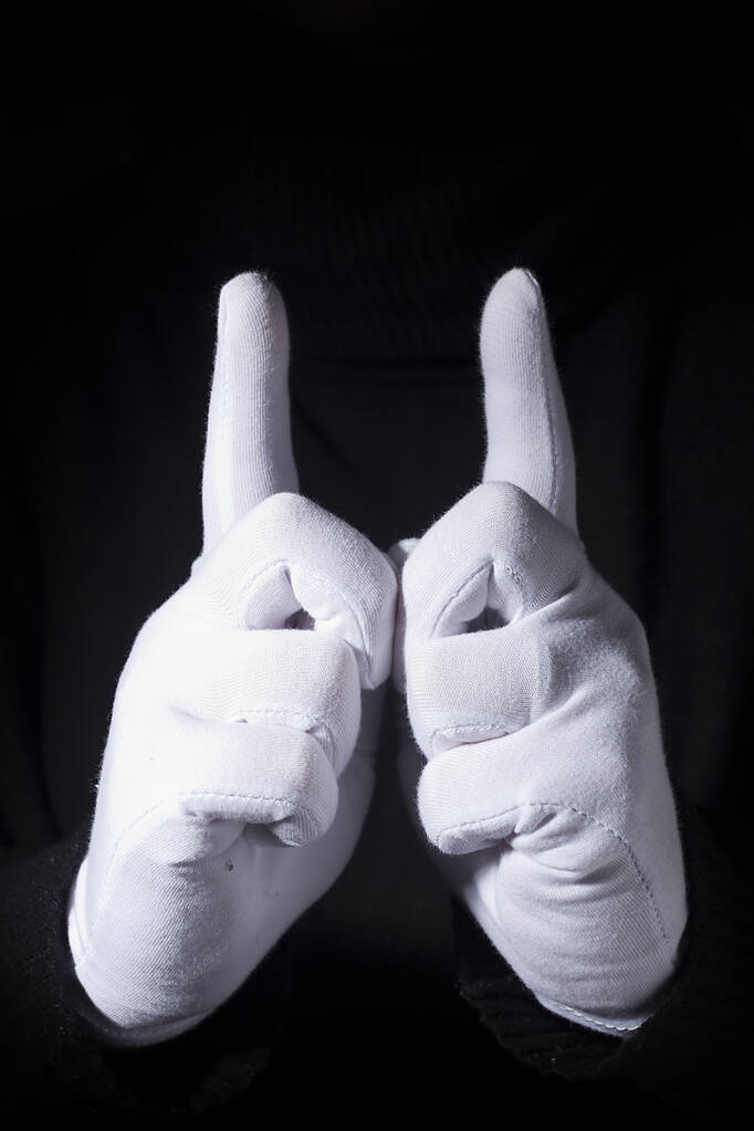 Mani in guanti bianchi con indice alzato
. - Foto, immagini