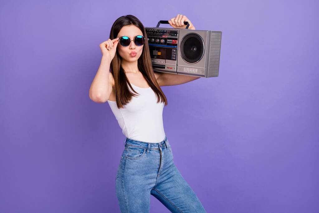 Portrait of romantic stunning girl rock star music lover hold retro boom box send air kiss wear spectacles jeans tank-top isolated over purple color background - Photo, Image