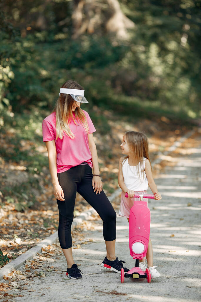 Mutter mit Tochter spielt im Sommerpark - Foto, Bild