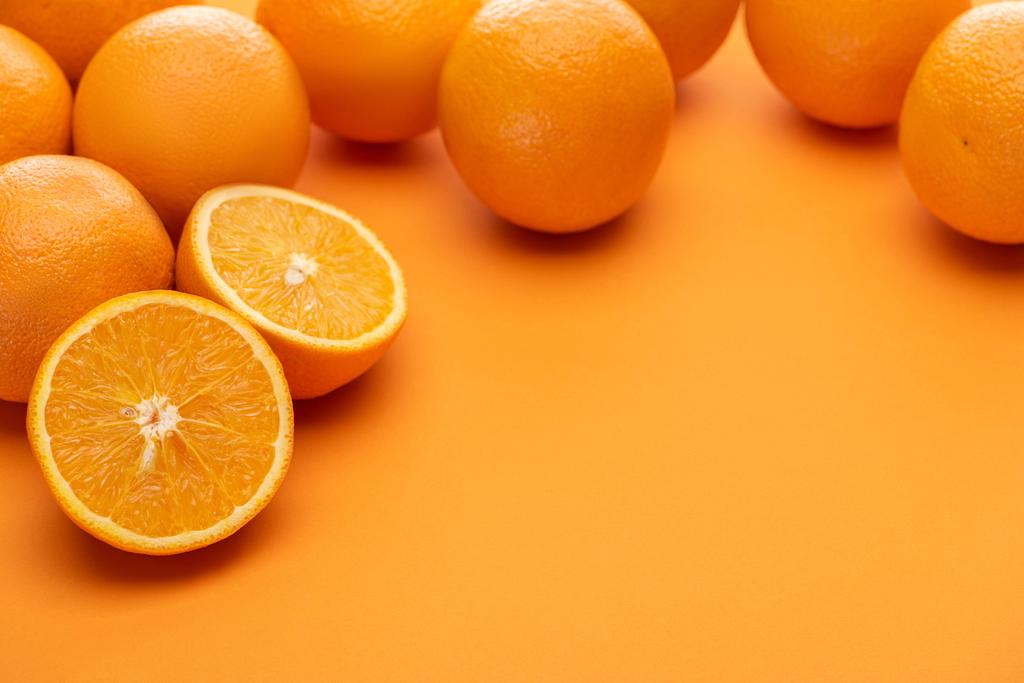ripe delicious cut and whole oranges on colorful background - Photo, Image
