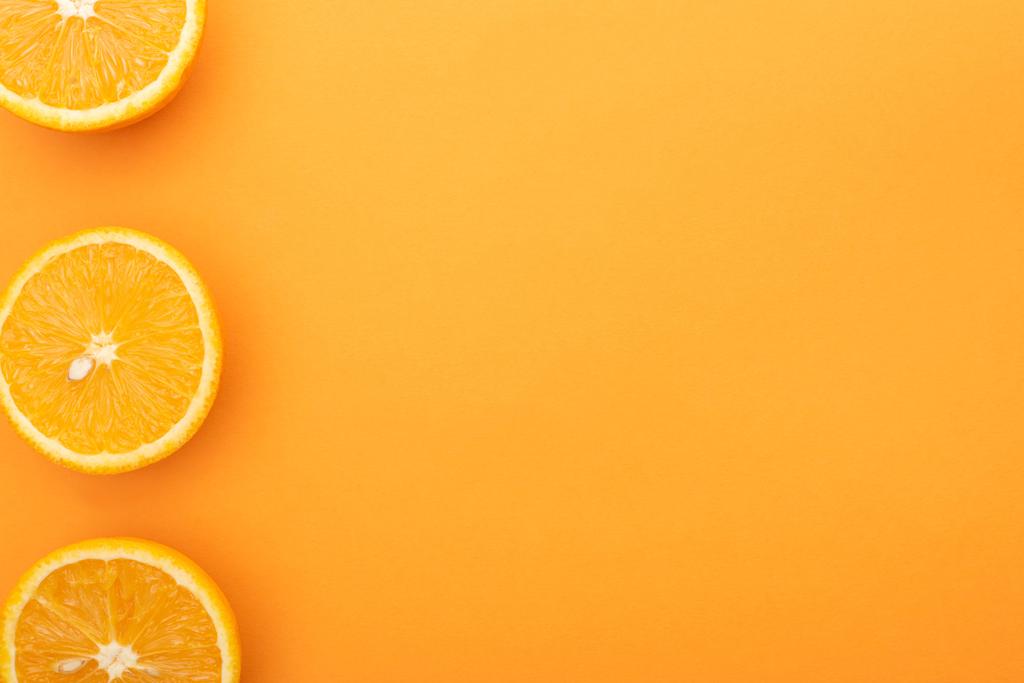 top view of ripe juicy orange slices on colorful background with copy space - Photo, Image