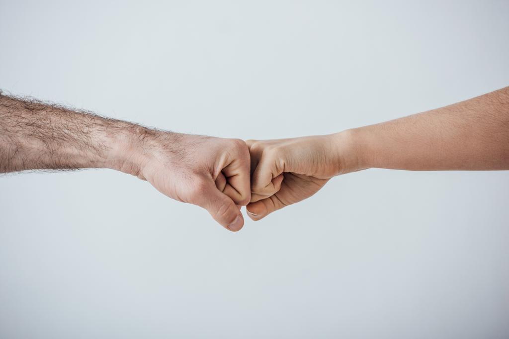 Cropped view of men doing fist bump gesture isolated on grey - Photo, Image