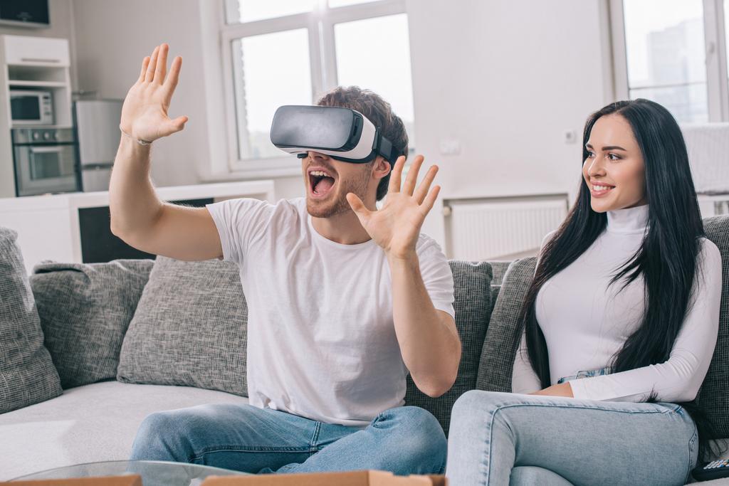 beautiful woman looking at excited in virtual reality headset during self isolation at home  - Photo, Image