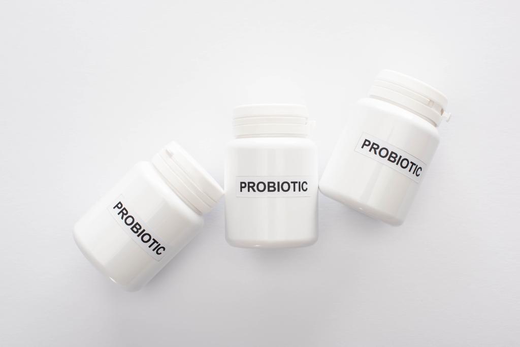 top view of containers with probiotic lettering on white background - Photo, Image