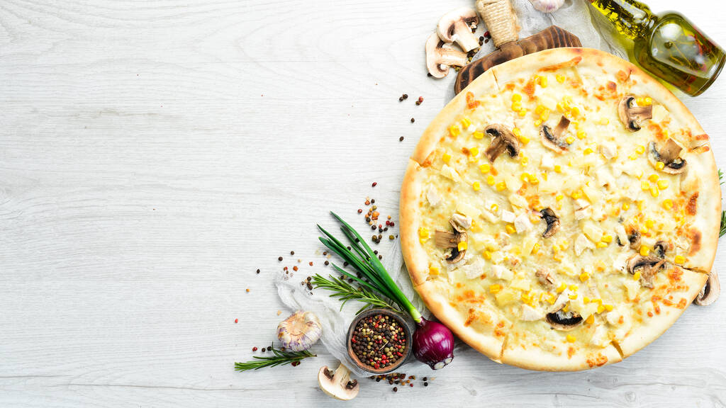 Hawaiian pizza with chicken, pineapple and mushrooms on the table. Rustic style. Top view. - Photo, Image