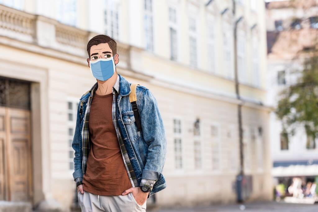 Handsome man with illustrated face in medical mask and hands in pockets on street - Photo, Image