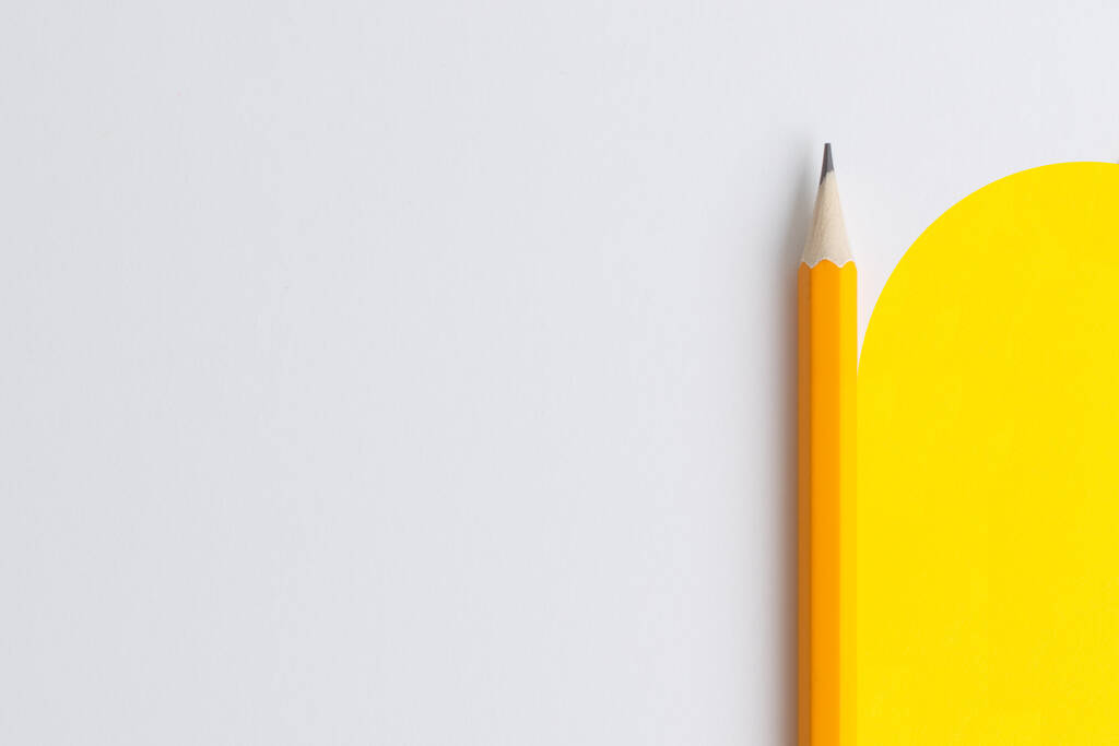 An interactive photo composition of an orange pencil and space for creative thinking (text) is used for presentation in the field of education, business or creativity. Lighting on a pencil in the studio. Yellow white background - Photo, Image