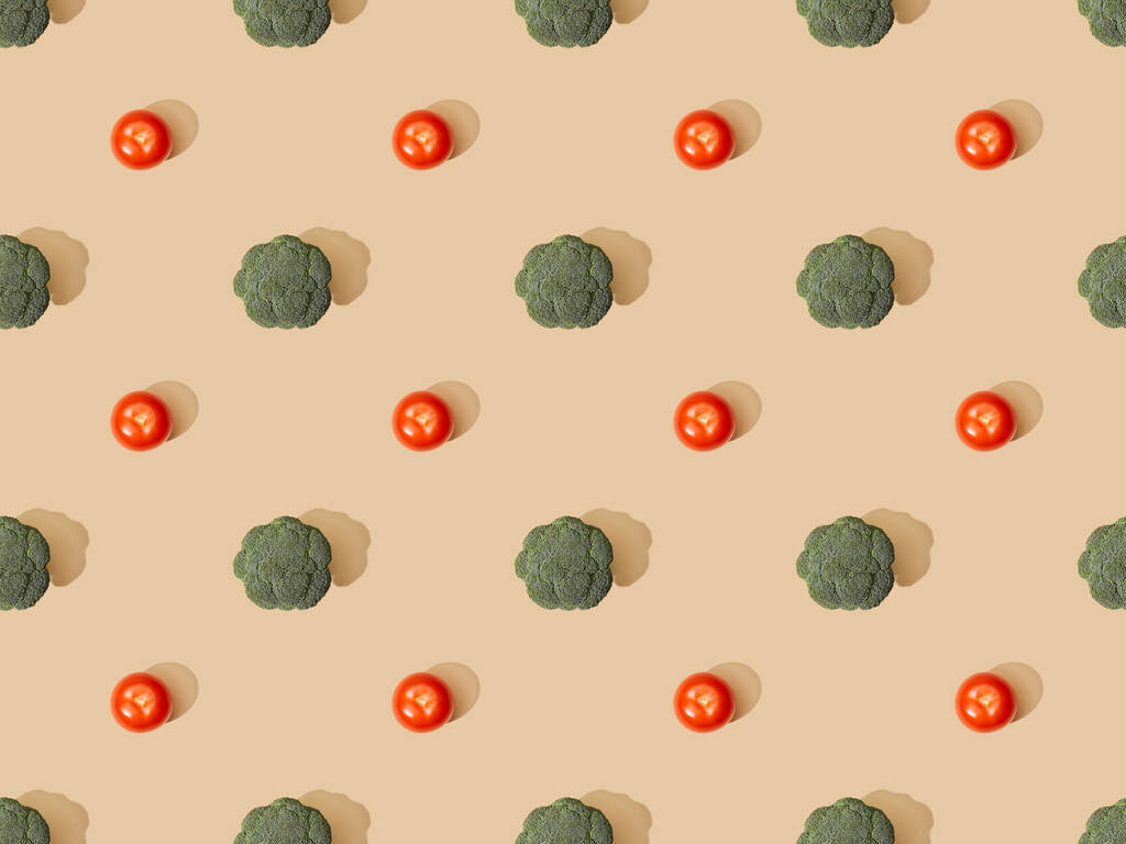 top view of fresh green broccoli and tomatoes on beige background, seamless pattern - Photo, Image