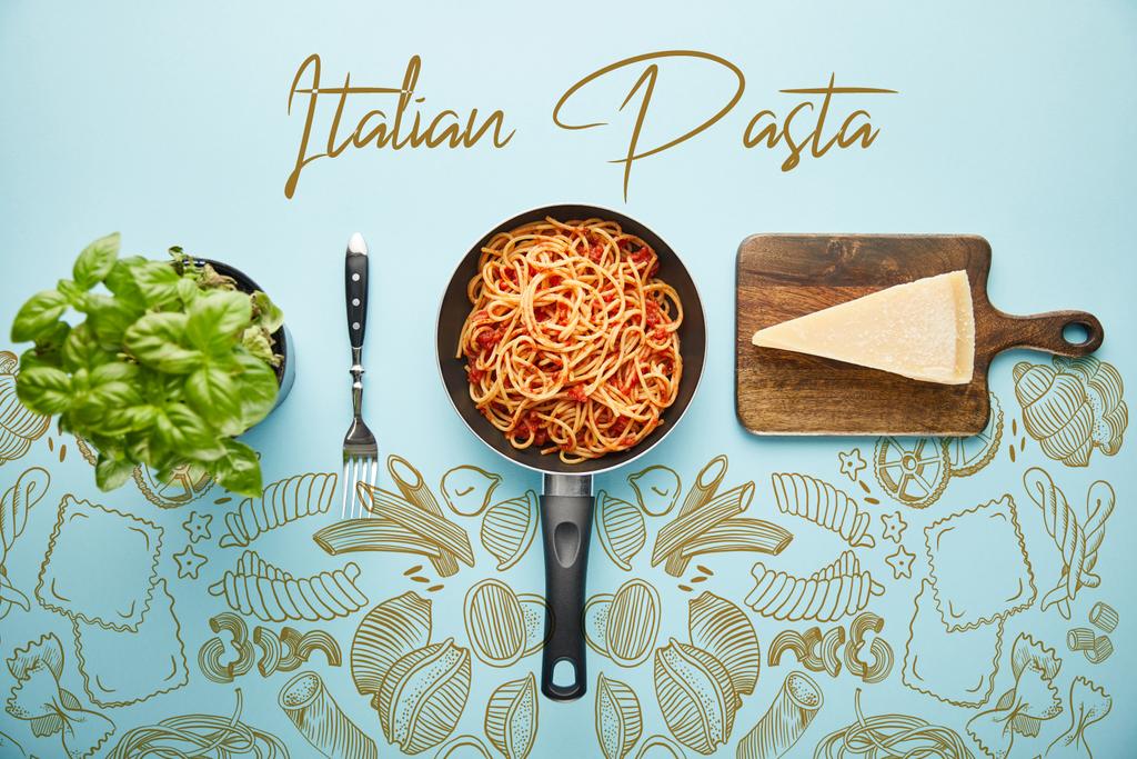 flat lay with delicious spaghetti with tomato sauce in frying pan near basil leaves and parmesan cheese on blue background with vegetables illustration - Photo, Image