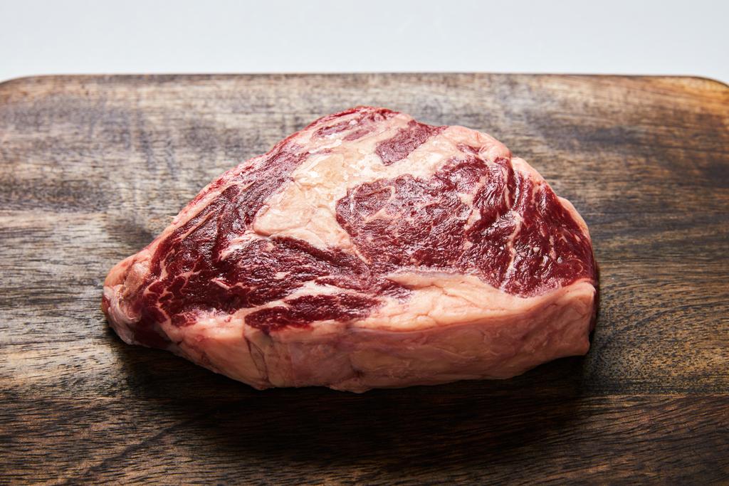 fresh raw steak on wooden cutting board - Photo, Image