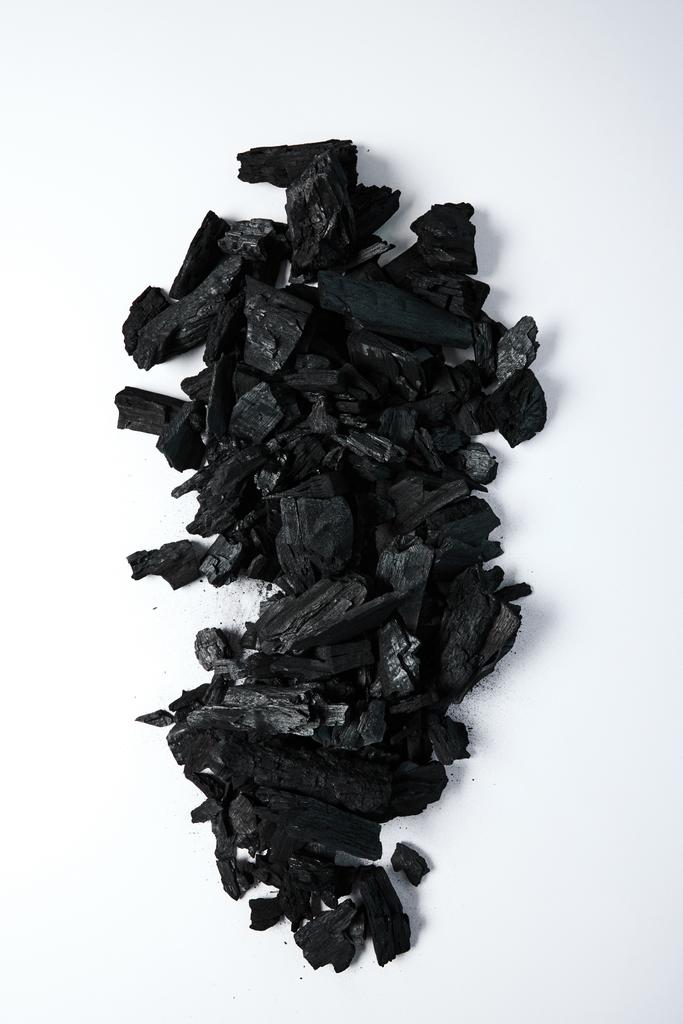 top view of black coals on white background - Photo, Image