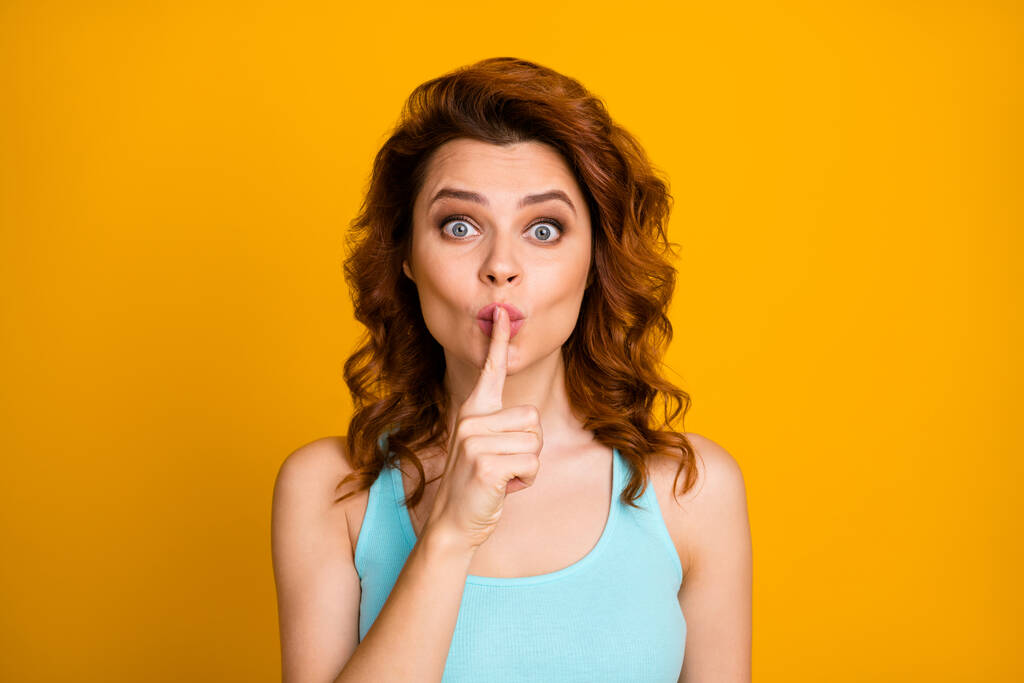 Shh. Closeup photo of pretty sly foxy wavy lady hold finger on lips tricky mood arrange surprise party for friends wear teal casual tank-top isolated bright yellow color background - Photo, Image