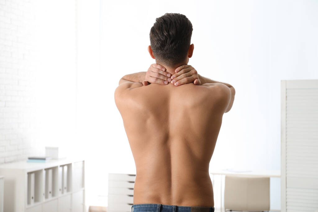Man suffering from pain in neck at clinic. Visiting orthopedist - Photo, Image