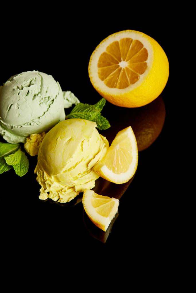 fresh delicious lemon and mint ice cream isolated on black - Photo, Image