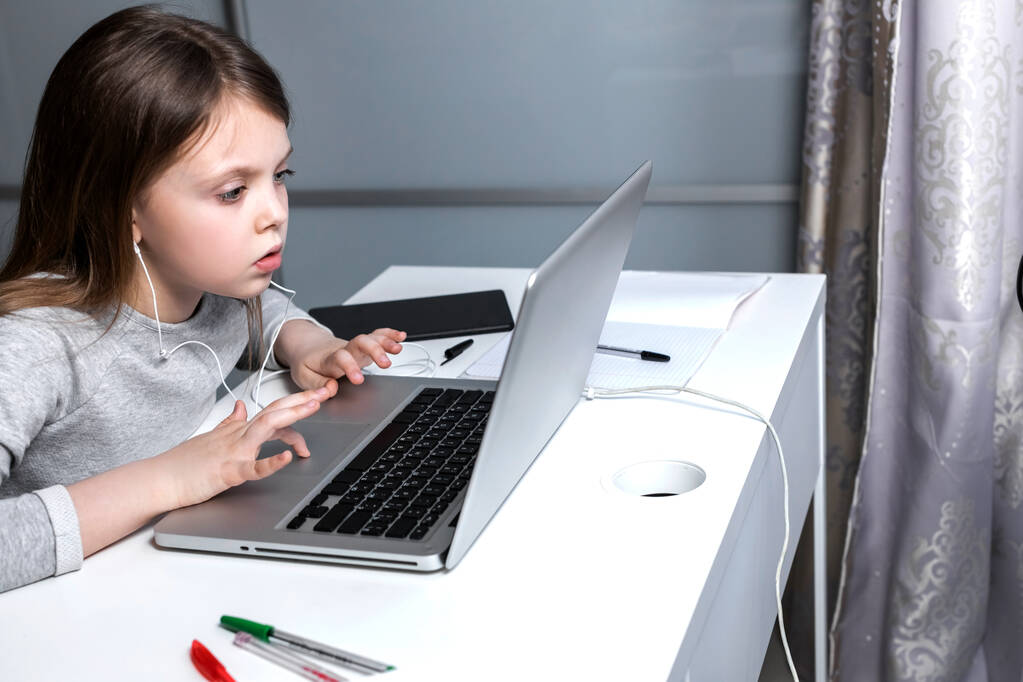 Cute girl connecting with a laptop at home, education concept at home. Education, online study, science, distance learning, homework, schoolgirl children lifestyle concept. Online education for kids. - Photo, Image