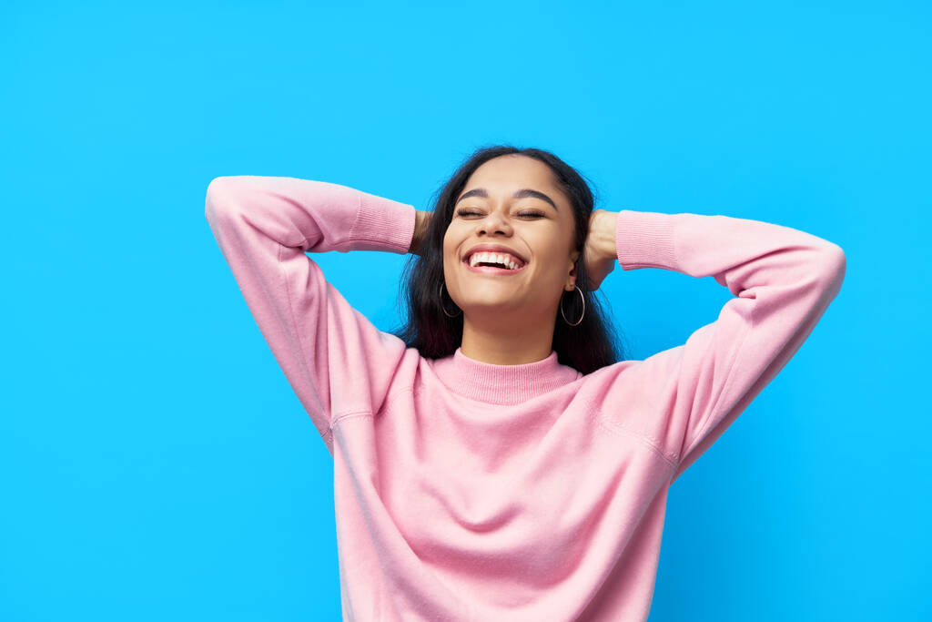 Happy laughing black woman on blue background - Photo, Image