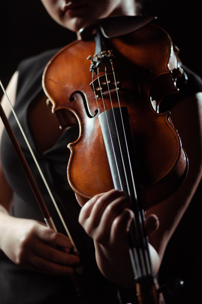 partial view of professional musician playing on violin isolated on black - Photo, Image