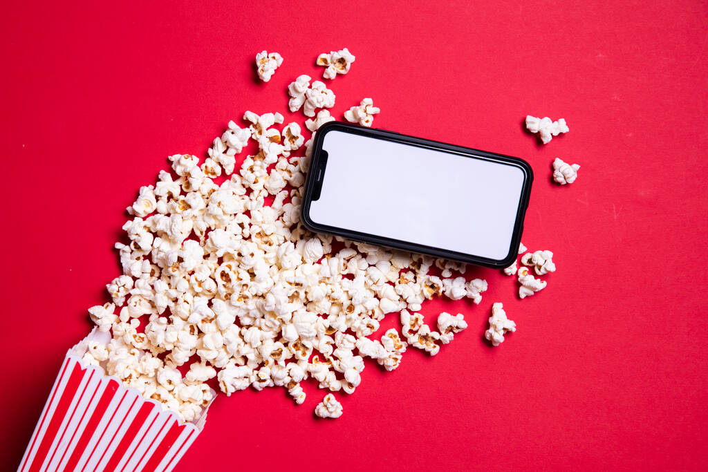LONDRA, Regno Unito - 14 MAGGIO 2020: Schermo vuoto per iphone Apple con popcorn al cinema
 - Foto, immagini