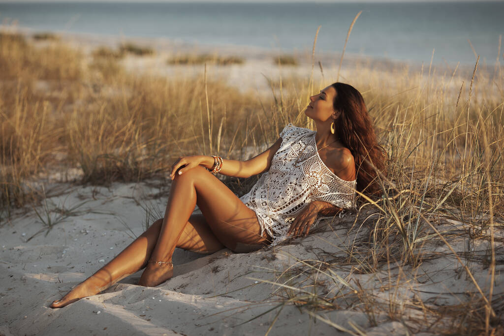 Vrouw rustend op het strand tijdens vakanties - Foto, afbeelding