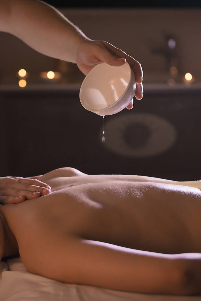 Wellness back massage with coconut oil for a beautiful girl and body treatments - Photo, Image