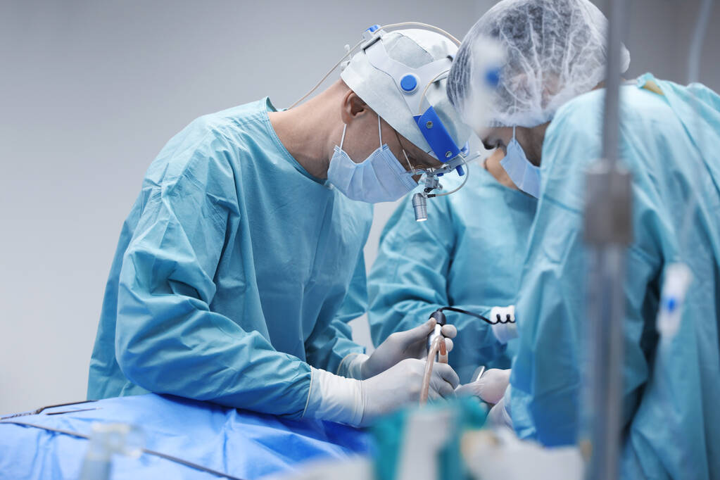 Equipo de médicos profesionales que realizan operaciones en sala de cirugía - Foto, Imagen
