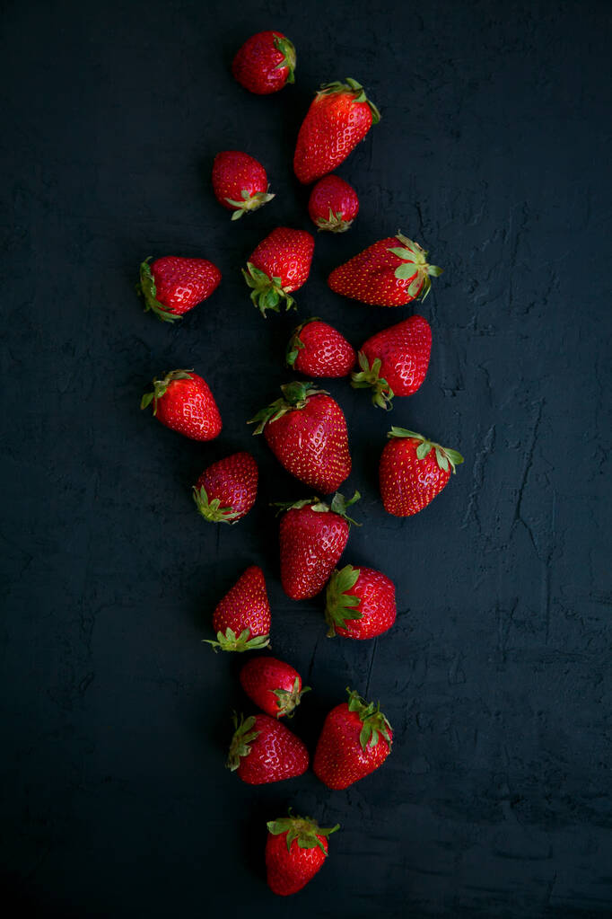 Fresh red strawberries on a black background, top view - Photo, Image