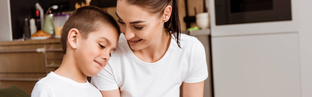 Panoramatická orientace usměvavé matky při pohledu na syna doma  - Fotografie, Obrázek