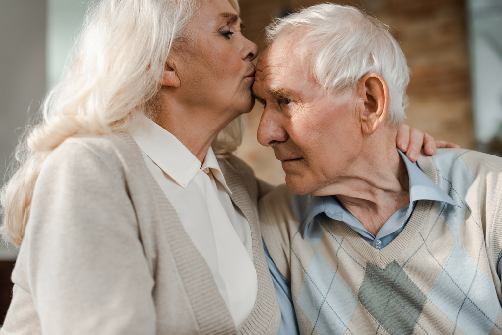 ηλικιωμένη σύζυγος που ελέγχει τη θερμοκρασία του συζύγου στο σπίτι σε καραντίνα - Φωτογραφία, εικόνα