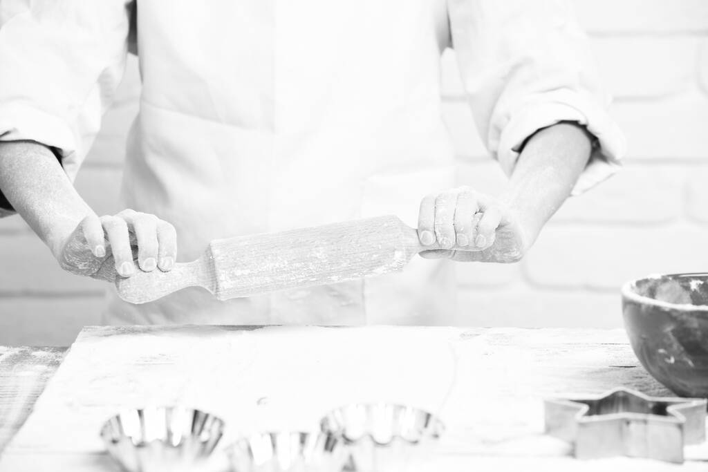 male hands of cook chef on brick wall background - Photo, Image