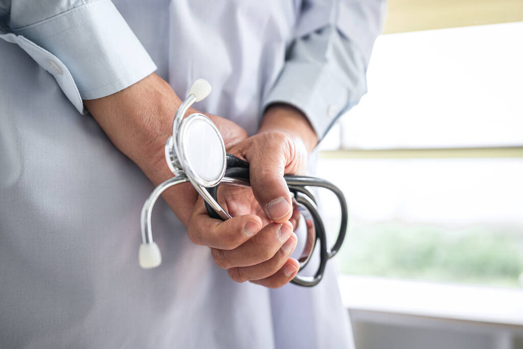 Close up of Mature doctor holding a stethoscope in hospital. - Photo, Image