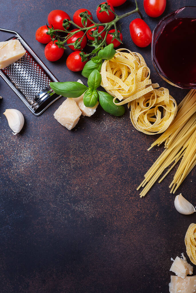 Image vue du dessus avec un espace de copie de spaghettis, tagliatelles, tomate, basilic, fromage, ail et vin. Concept d'une cuisine italienne saine
 - Photo, image