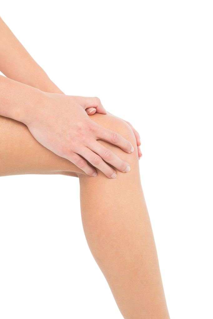 Close-up seção média de uma mulher com dor no joelho
 - Foto, Imagem