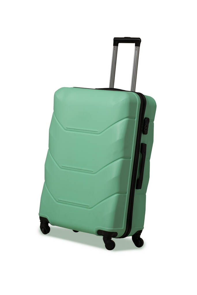 車輪と格納式伸縮ハンドル付きプラスチックスーツケース。ライトグリーンのスーツケースまたは大きなバッグ用旅行荷物。旅のコンセプト。白地に切り取る - 写真・画像