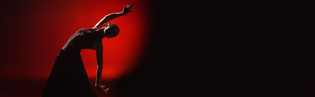 orientamento panoramico della giovane donna che danza il flamenco su rosso e nero
  - Foto, immagini