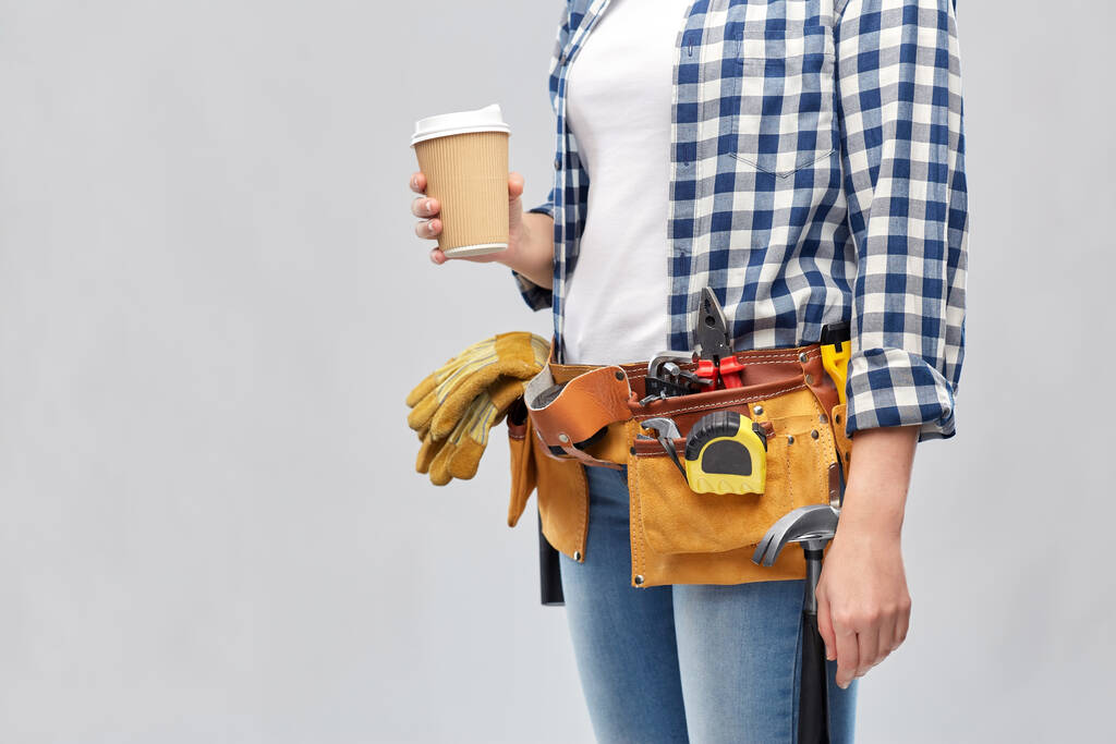 женщина с чашкой кофе на вынос и рабочими инструментами - Фото, изображение