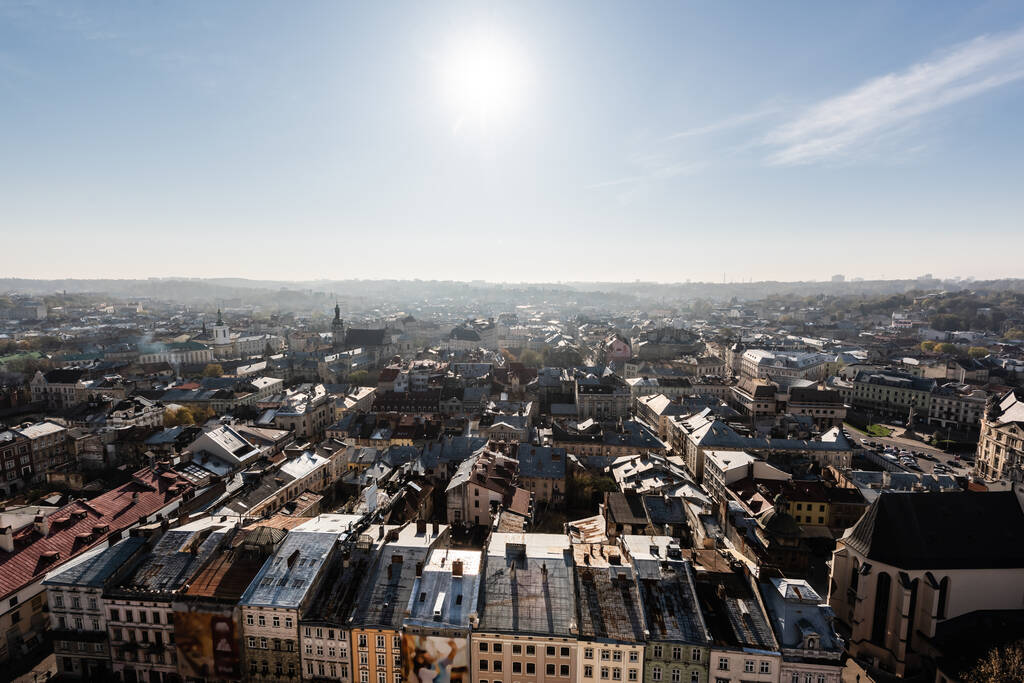scenic aerial view of city with bright sun on blue sky, lviv, ukraine - Photo, Image