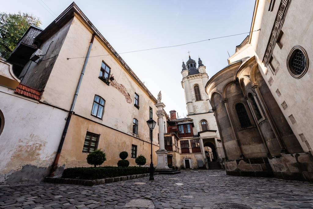 rua com casas antigas que levam à igreja carmelita em lviv, ucraniana
 - Foto, Imagem