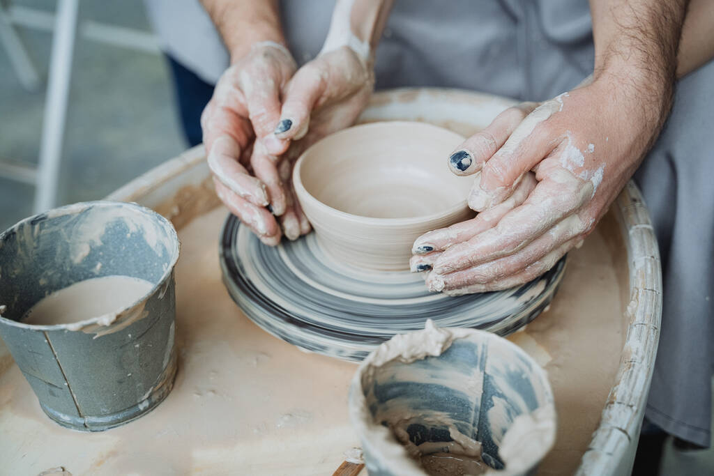 Potter's wheel, pottery workshop, working with clay, clay, clay modeling, modeling, ceramics, hands made of clay, clay pot, stained in clay, dirty hands, creativity, workshop, hands, planters - Photo, Image