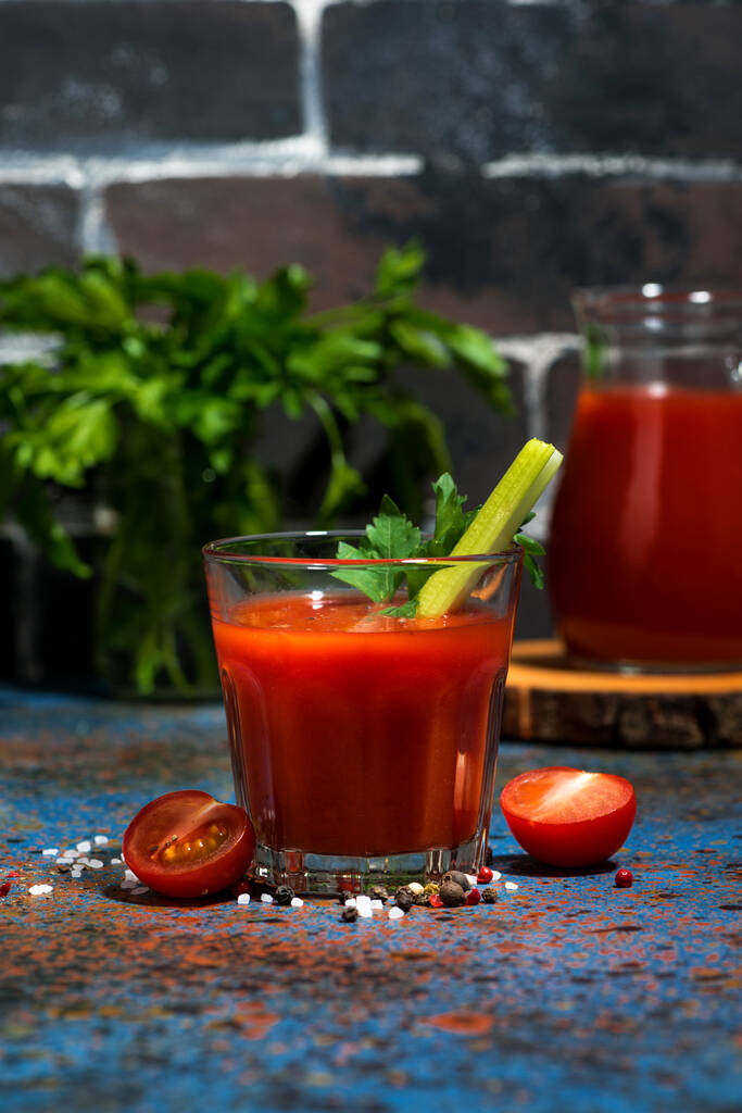 healthy tomato juice with salt and celery on dark background, vertical - Photo, Image