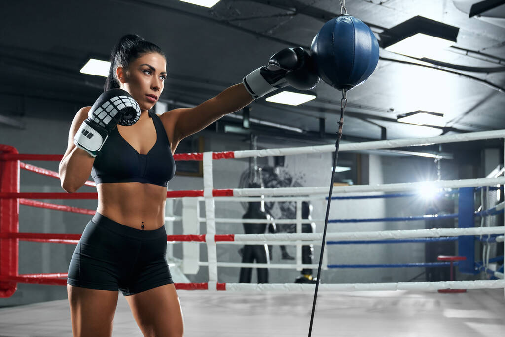 Sportswoman training in boxing gloves. - Photo, Image