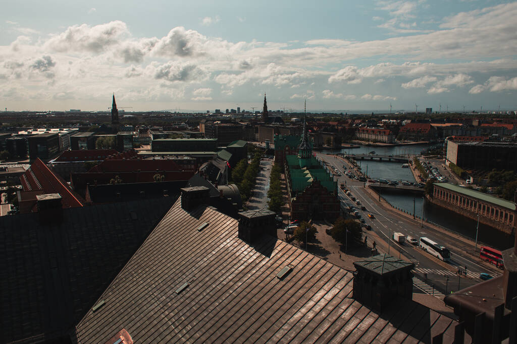 Hochwinkelaufnahme von Gebäuden und Kanal mit bewölktem Himmel im Hintergrund in Kopenhagen, Dänemark  - Foto, Bild