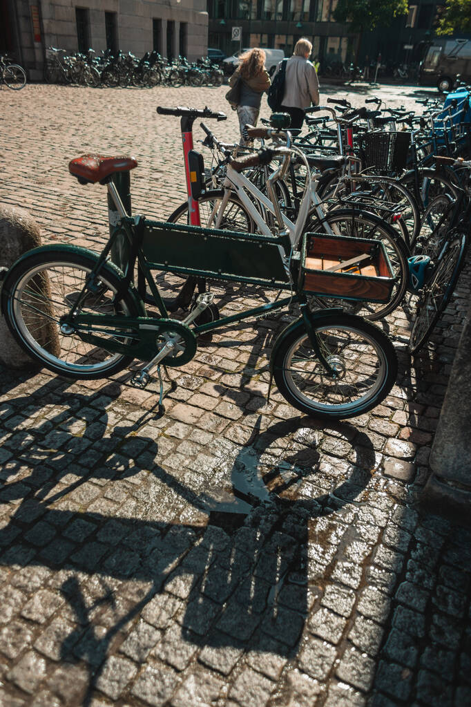 Ποδήλατα σε πλακόστρωτο πέτρινο διάδρομο σε αστικό δρόμο της Κοπεγχάγης, Δανία  - Φωτογραφία, εικόνα