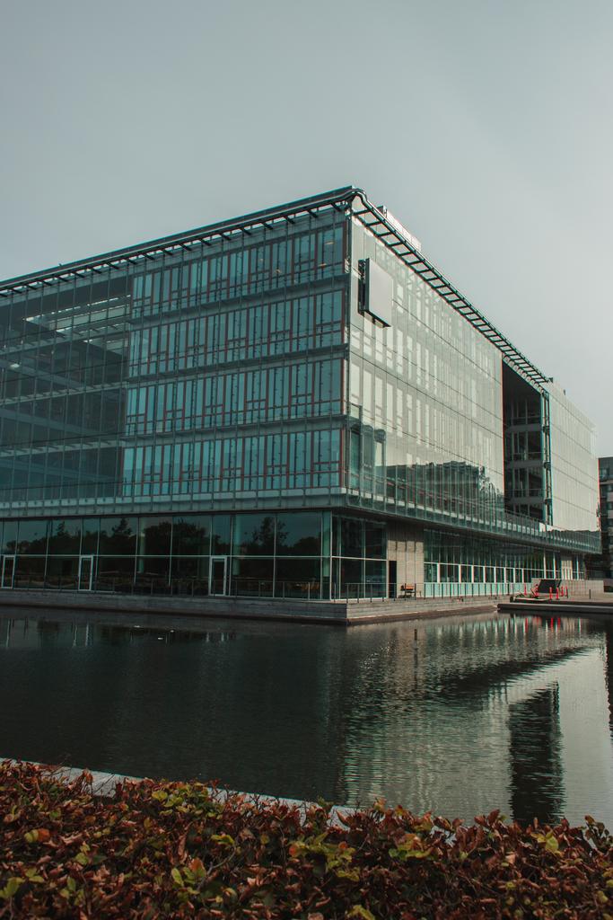 Selective focus of building with glass facade near canal on urban street in Copenhagen, Denmark  - Photo, Image